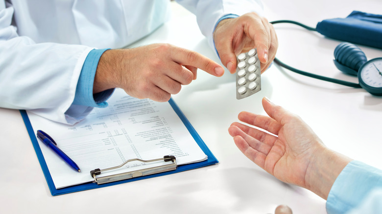Doctor prescribing medication to patient