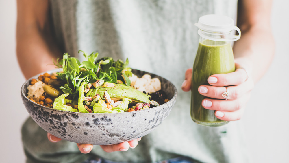 Closeup of a person with a salad and dressing