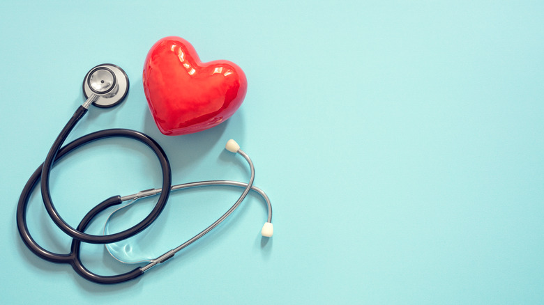 stethoscope and heart on green background