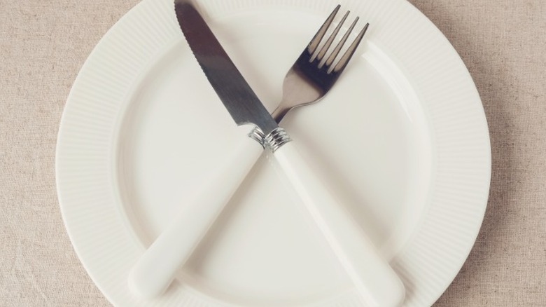 Plate with crossed fork and knife