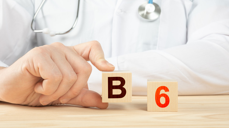 Doctor with blocks showing B and 6