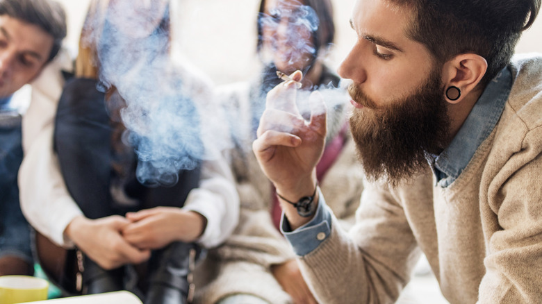 Man smoking in group