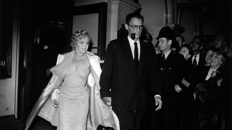 Marilyn Monroe leaves an event with her husband Arthur Miller