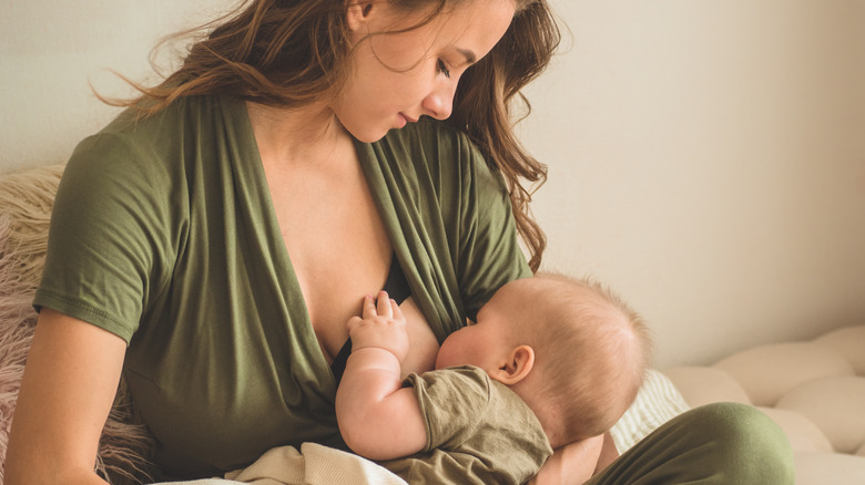 mother breastfeeds infant