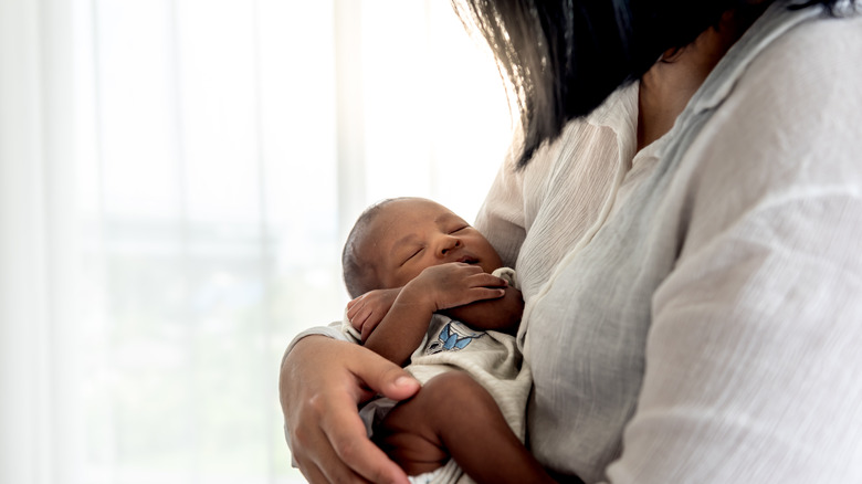 Black mother holding her newborn baby