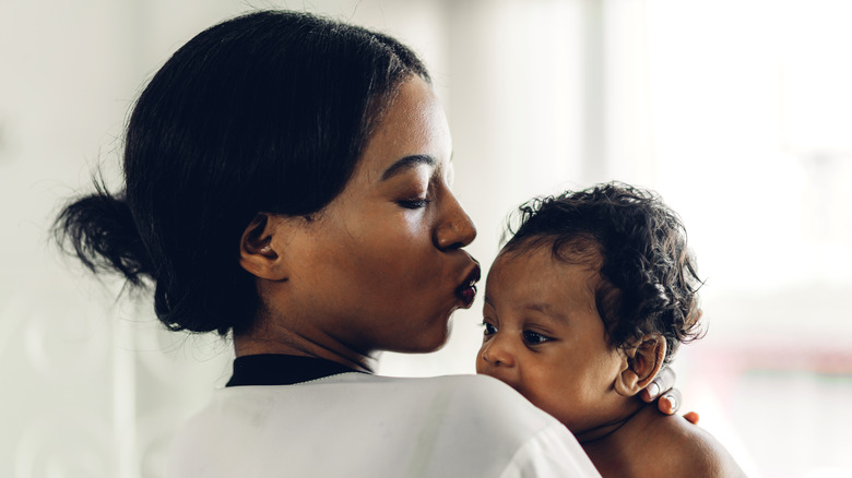 Black mother holding her infant