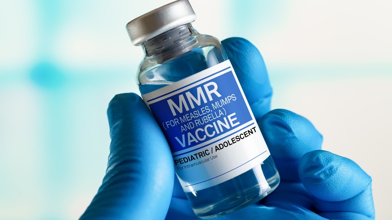 Hand holding MMR vaccine