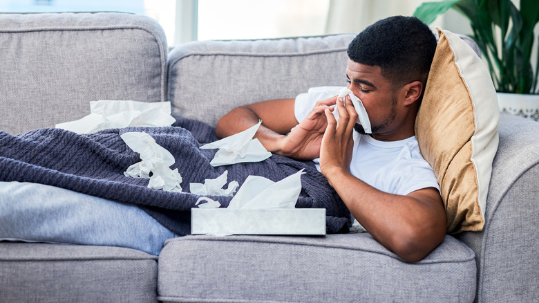 Man blowing nose