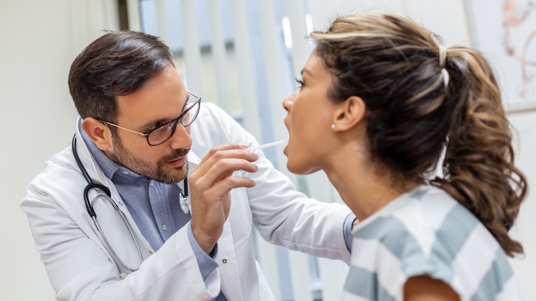 Doctor looking at throat