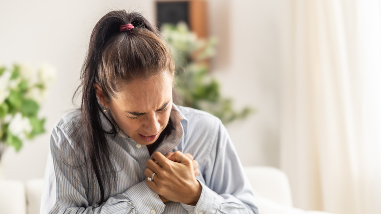 young woman feeling chest pain