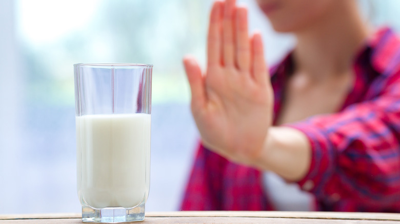 Woman refusing glass of milk