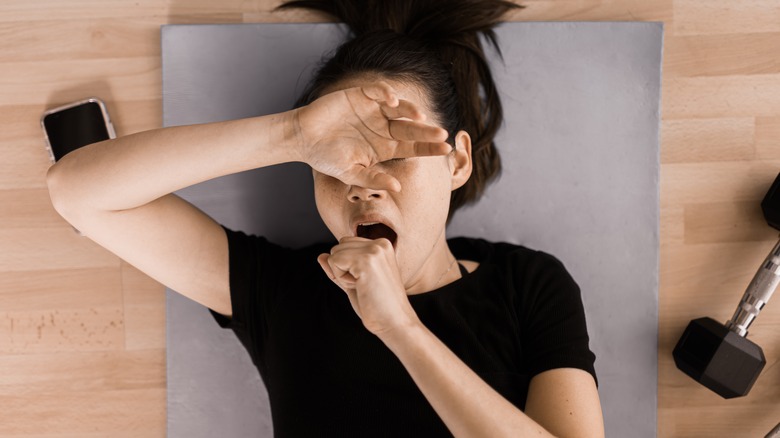 tired woman with weights