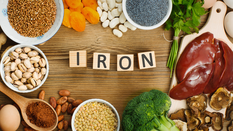 The word "Iron" spelled out in wooden blocks surrounded by iron-rich food