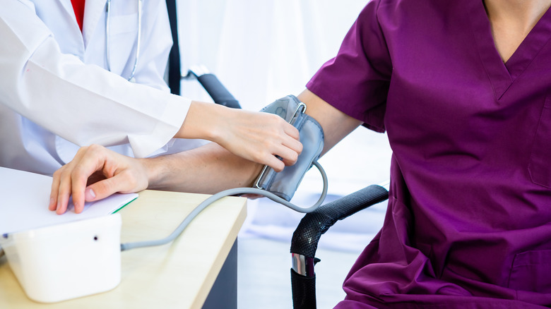 doctor taking blood pressure reading