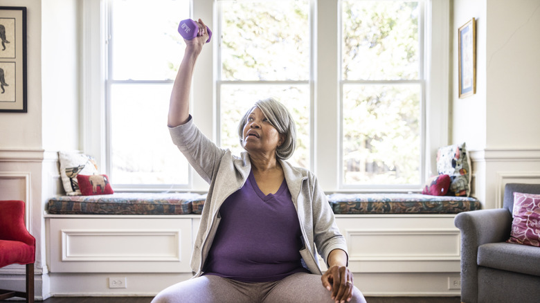 woman exercising in her home with weights