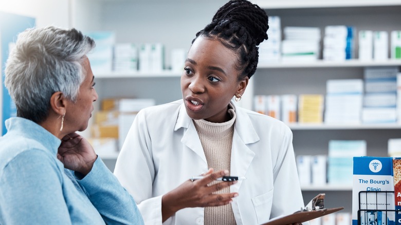 Pharmacist speaking to patient