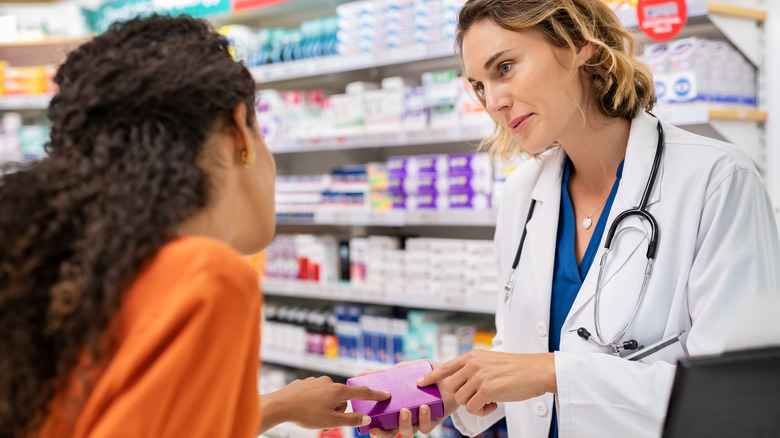 pharmacist discussing medications with customer