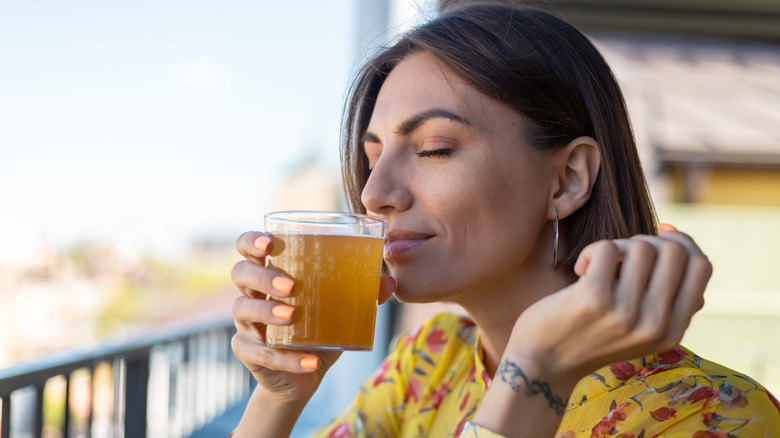 Woman drinking kombucha 