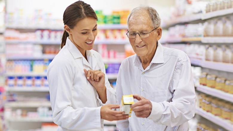 pharmacist and patient examine medicine