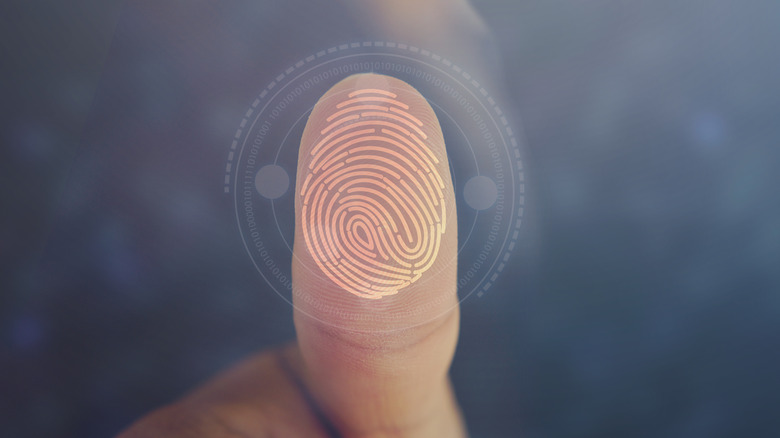 Close-up of a thumb with a fingerprint imposed over it