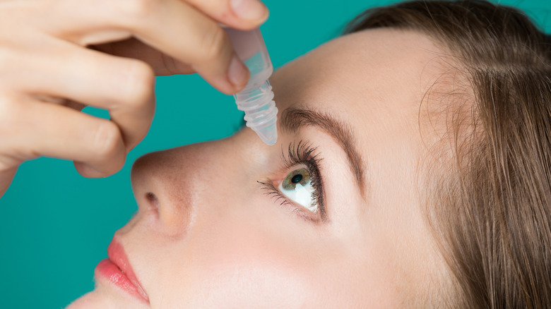 Close-up of a woman using eyedrops 
