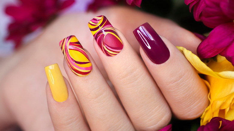 Close-up of four manicured fingernails 