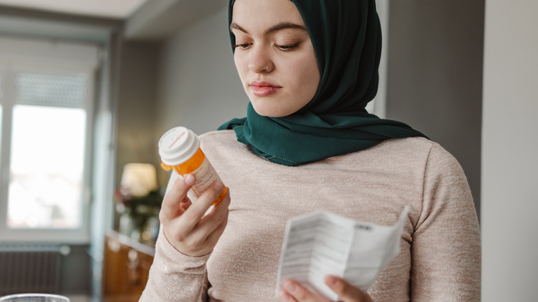 Woman reading prescription drug label