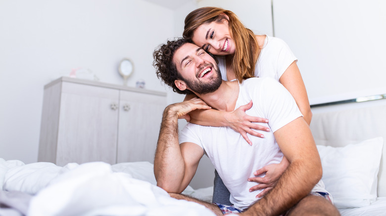 couple smiling in bed 