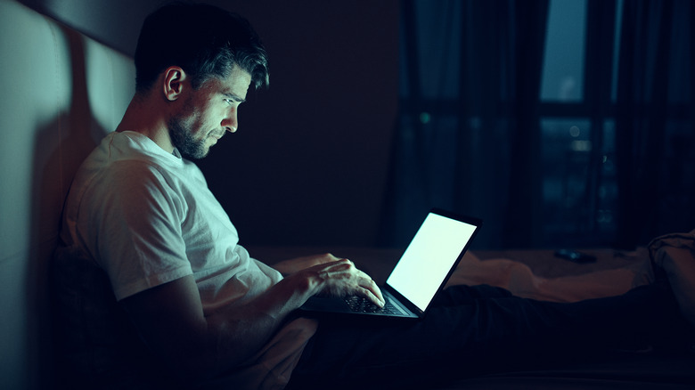 man on his laptop at night