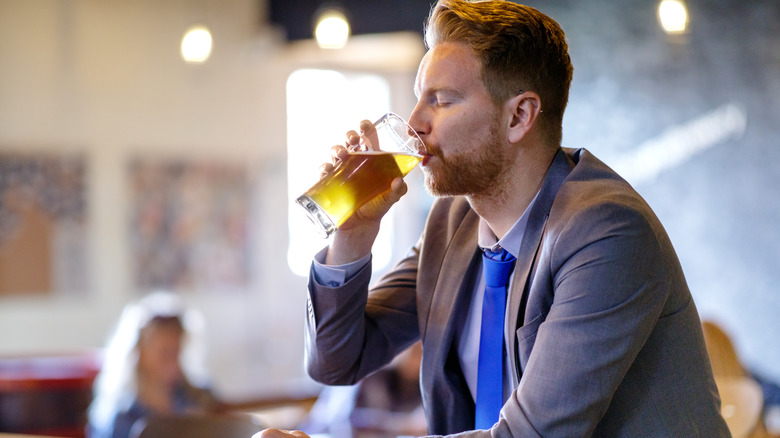 man drinking alchol at a bar