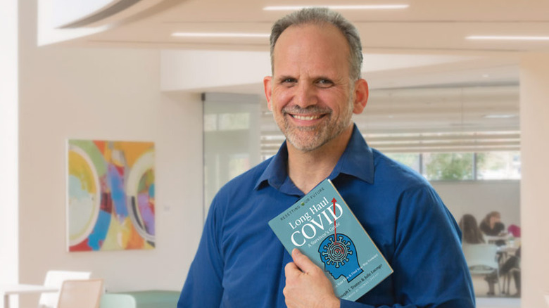 Dr. Joseph Trunzo holding his book