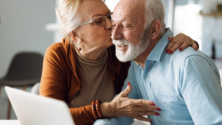 Older woman kissing man