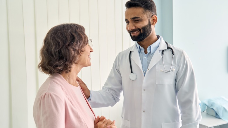 Doctor comforting patient in office