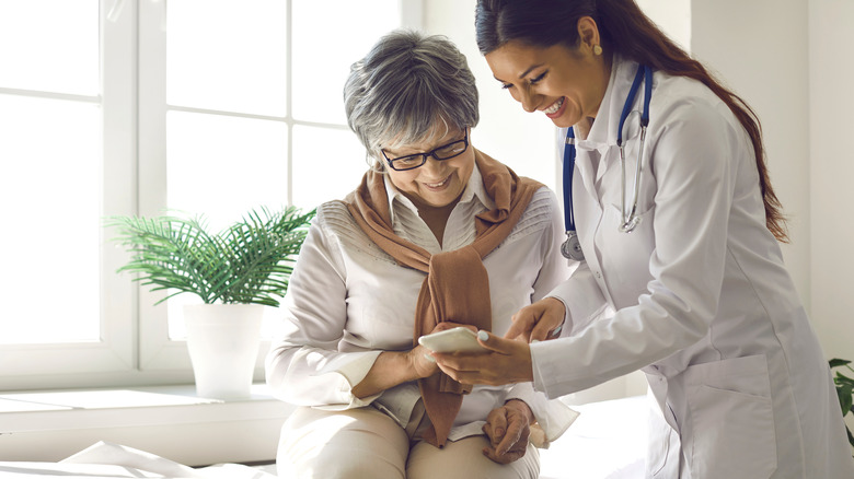 Doctor showing patient phone