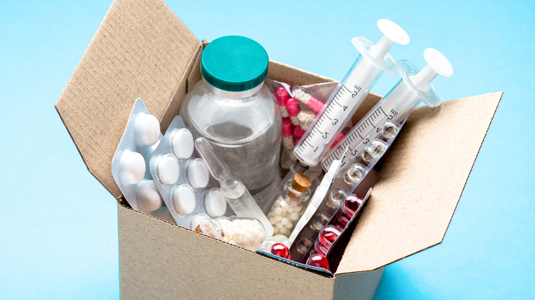 Pills and vials in a box