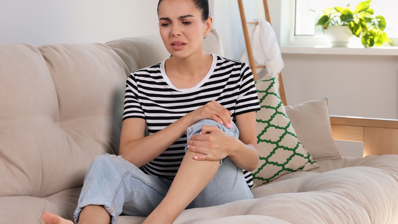 Woman holding her knee