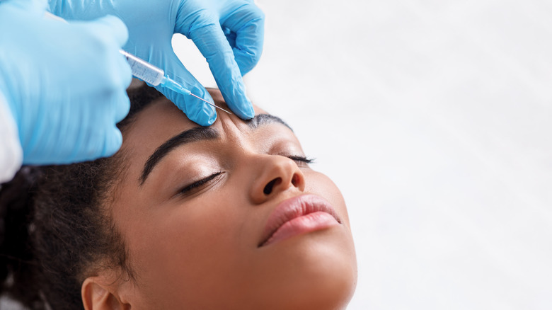 woman receiving injection in forehead