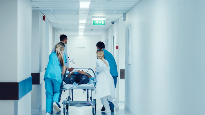 medical staff pushing patient on a gurney 