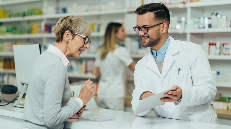 Pharmacist going over prescriptions with woman