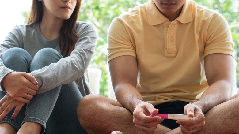 couple looks at pregnancy test 