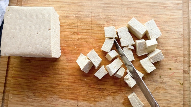 knife cutting tofu into cubes