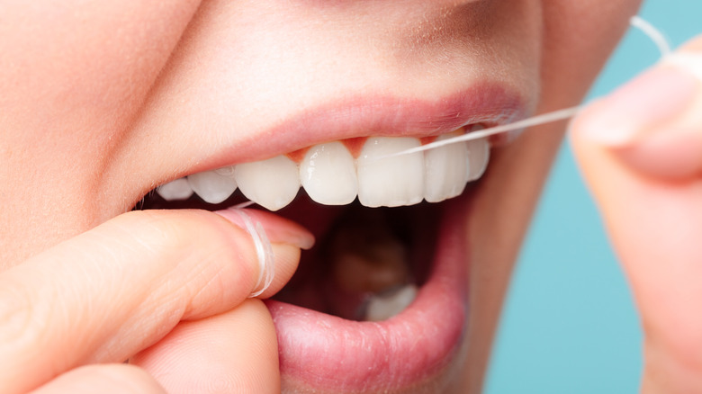 woman flossing closeup