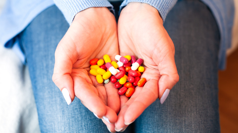 colorful pills cradled in hands