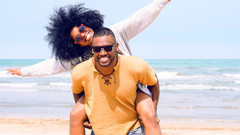 couple wearing sunglasses on beach