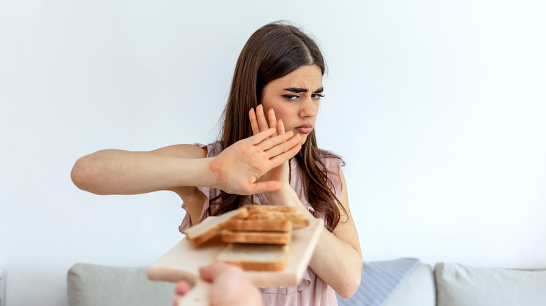 young girl saying no to bread