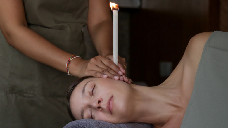 woman having ear candling treatment