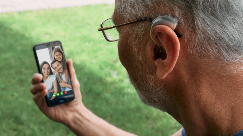 man with hearing aid video calling