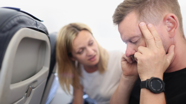 man in pain on flight