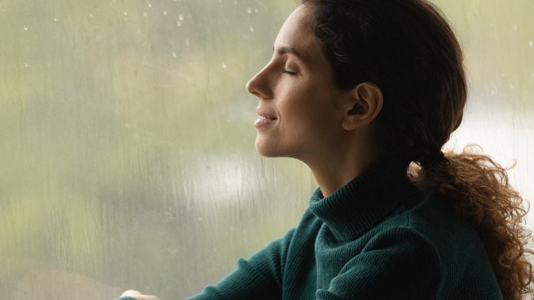 smiling woman with eyes closed