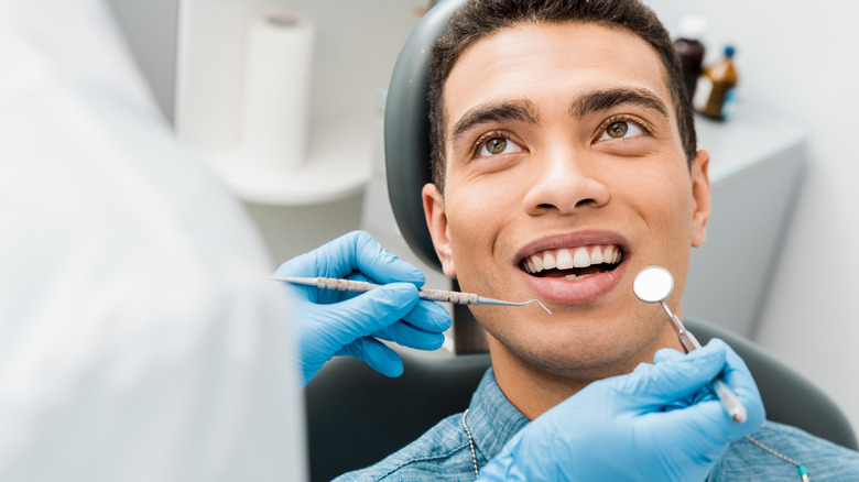 smiling man in dentist chair